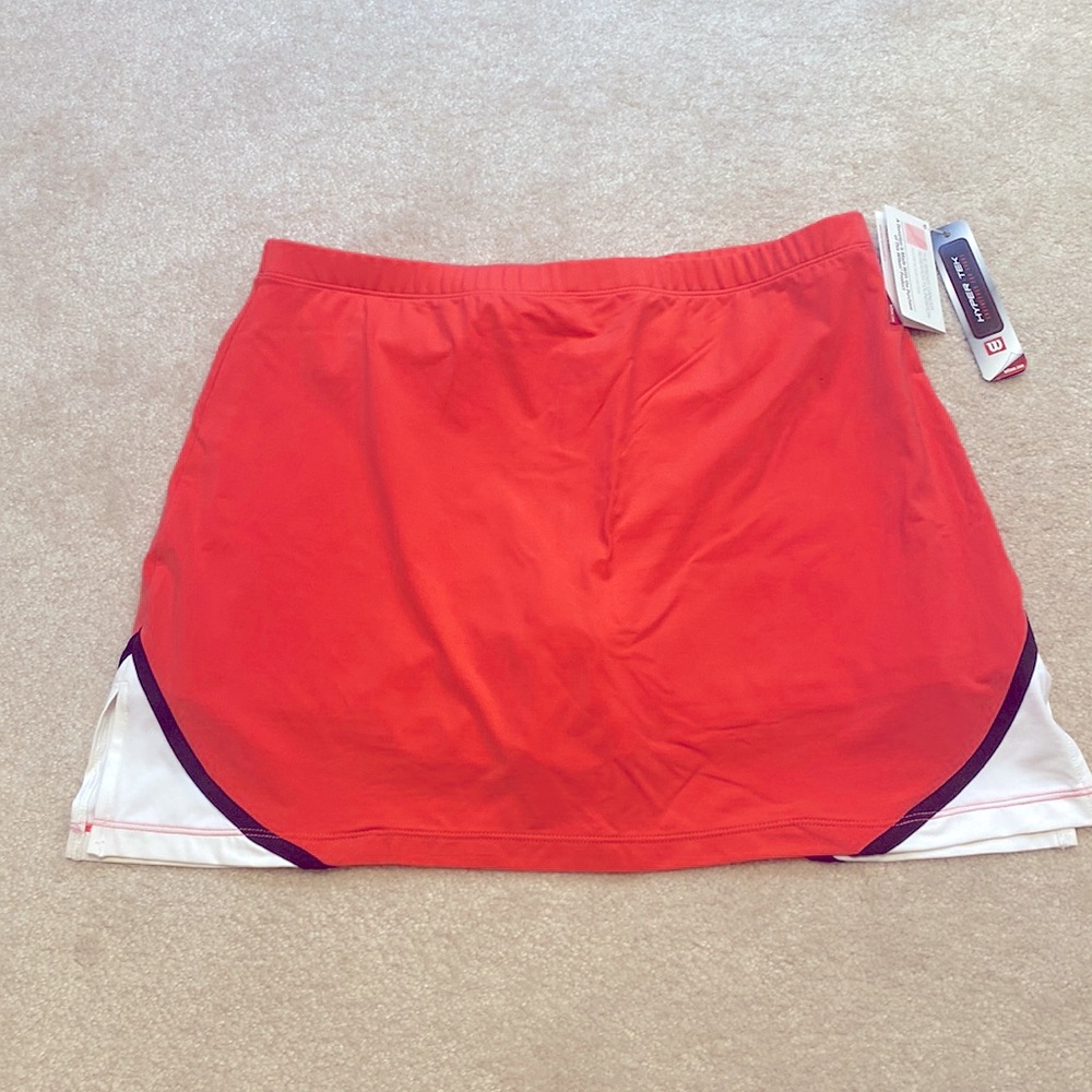 Wilson womens tennis skirt- new with tags - size medium. Coral pink/black/white